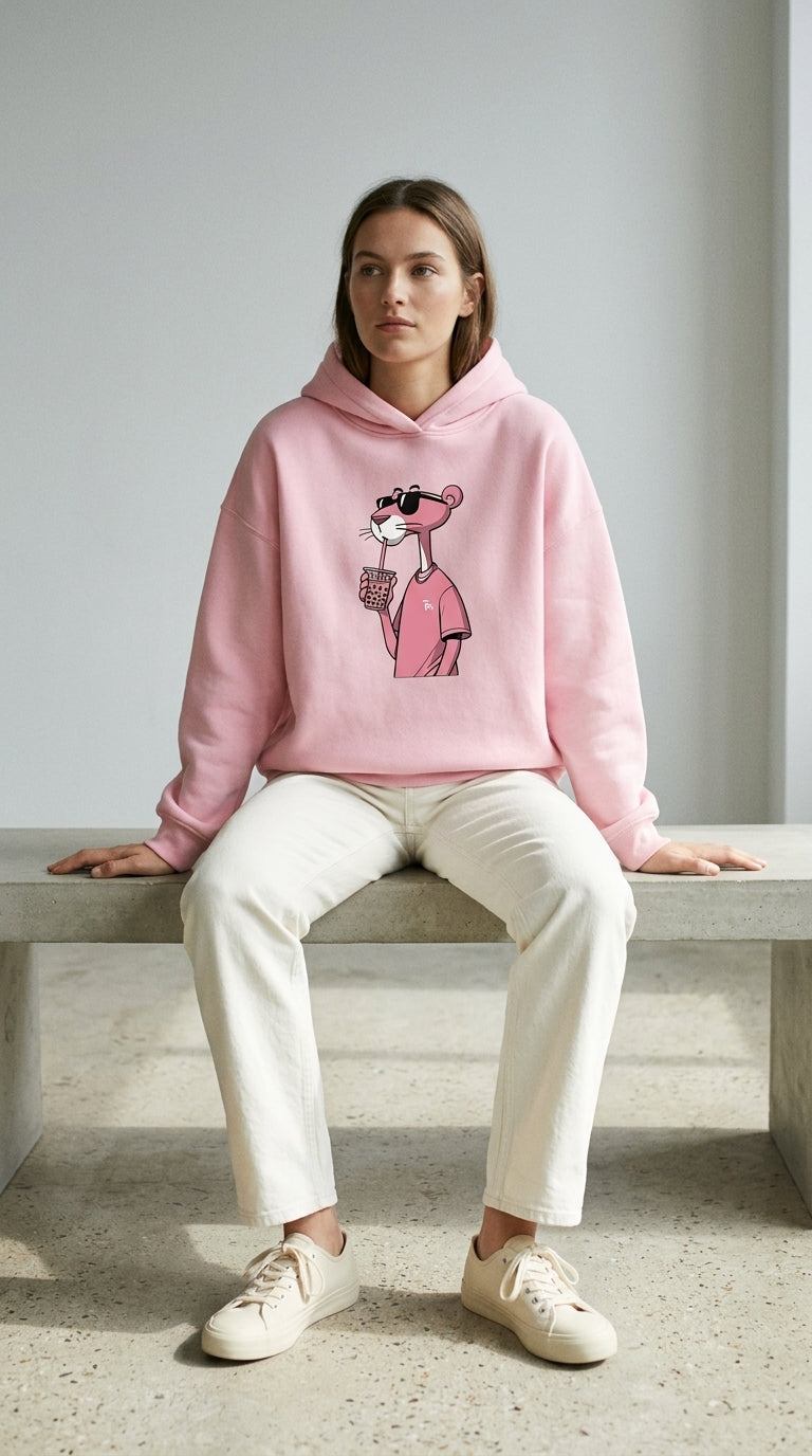 Pink Character Hoodie — model wearing a light pink hoodie with cartoon character graphic